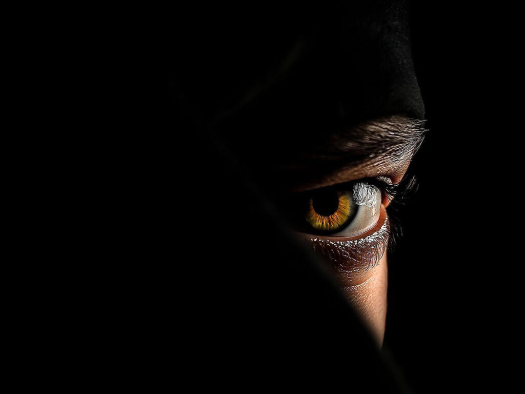 attacker looking from the darkness, at a student from WCKUK wing chun